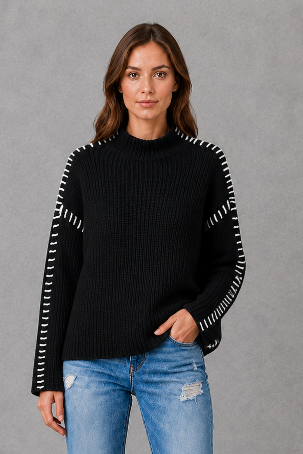 Women’s black oversized crew neck sweater with long sleeves and statement white contrast stitching along the shoulders and sleeves.