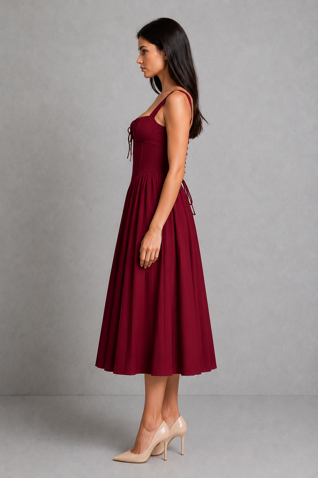 Women's corset midi dress featuring a structured boned bodice, sweetheart neckline, gathered tie-front cups, fan-shaped adjustable straps, lace-up back, and a flowing knife-pleated skirt, designed for elegant occasion and party wear.