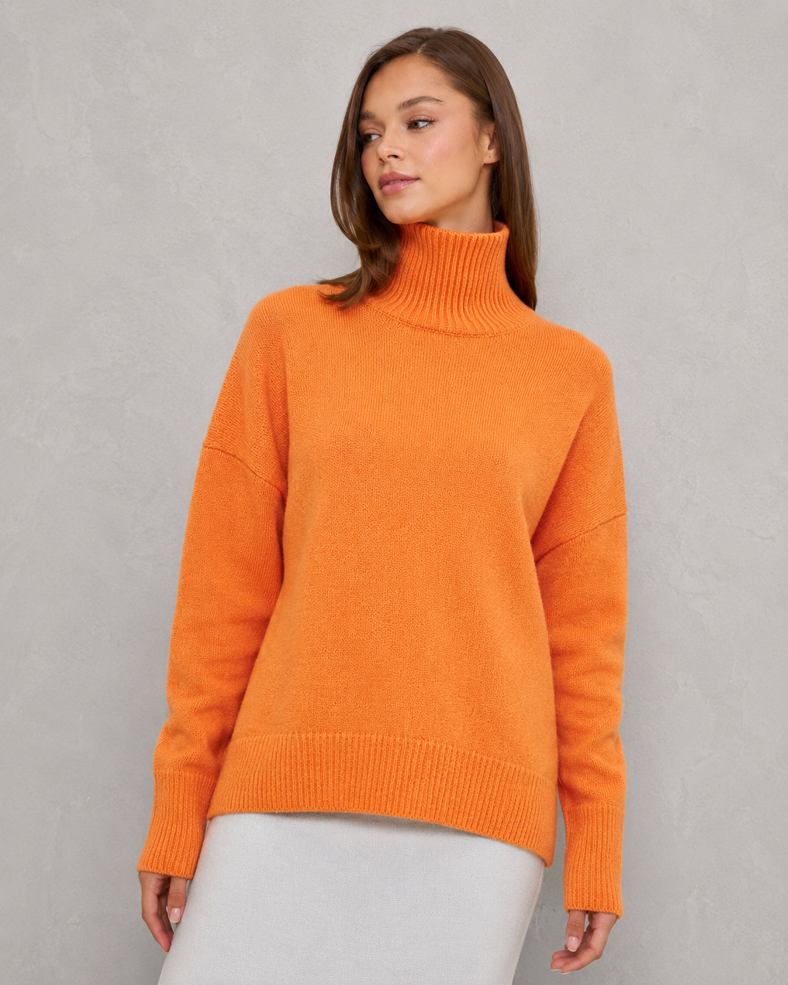 Women's cozy knitted turtleneck sweater in a relaxed, feminine silhouette with a softly structured fit. Features a refined high neckline, rich textured knit, and clean minimalist design that offers warmth and breathable comfort. A versatile wardrobe essential styled effortlessly with tailored trousers, denim, boots, or accessories for polished everyday wear from office settings to casual outings.