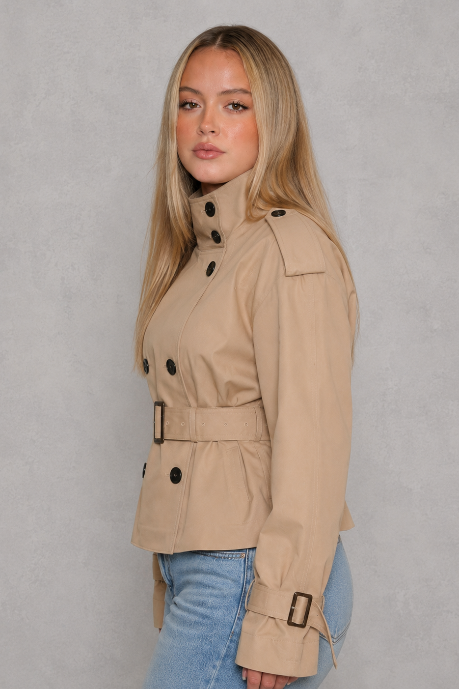 Women’s cropped belted trench coat with a double-breasted button front, structured lapel collar and adjustable tie waist.