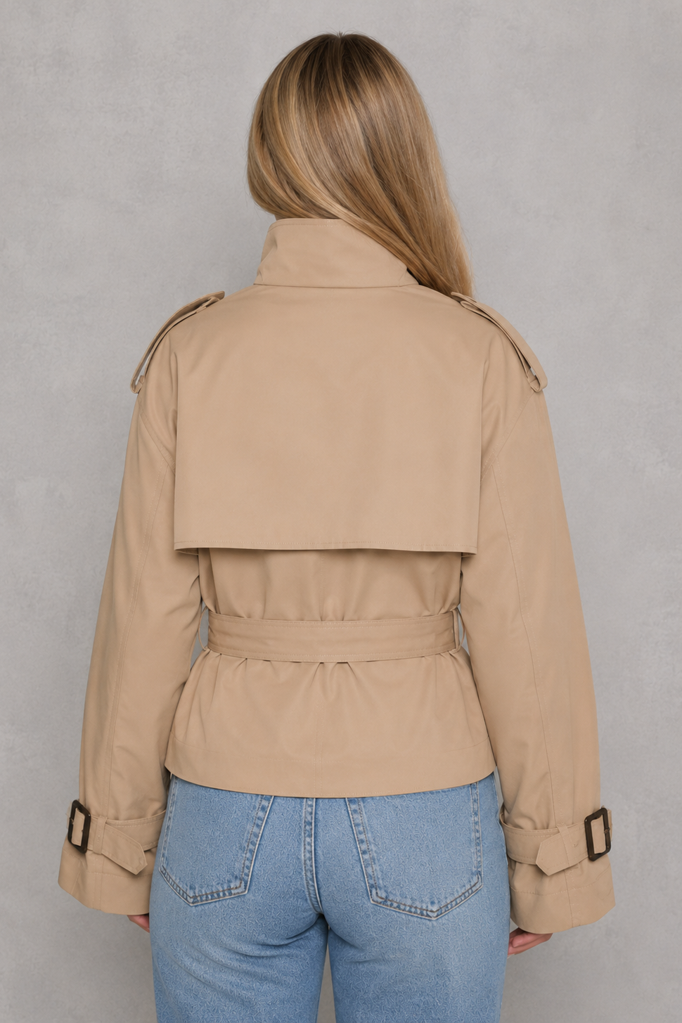 Women’s cropped belted trench coat with a double-breasted button front, structured lapel collar and adjustable tie waist.