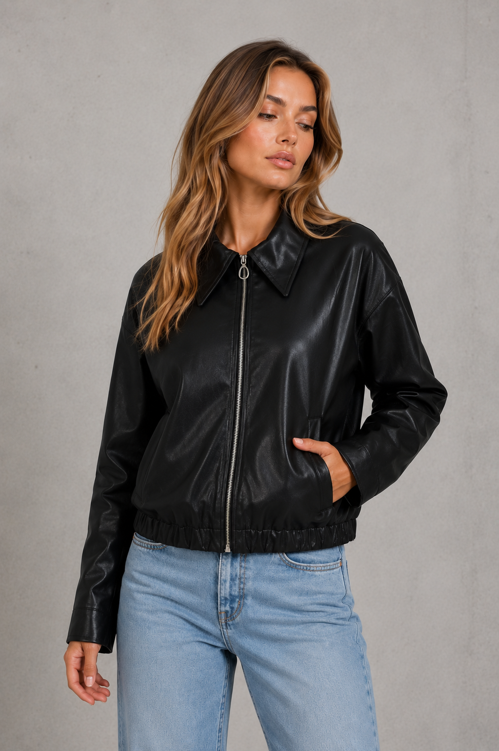 Women’s cropped faux leather jacket with zip front, oversized pointed collar, elasticized hem, and side pockets in a relaxed fit.
