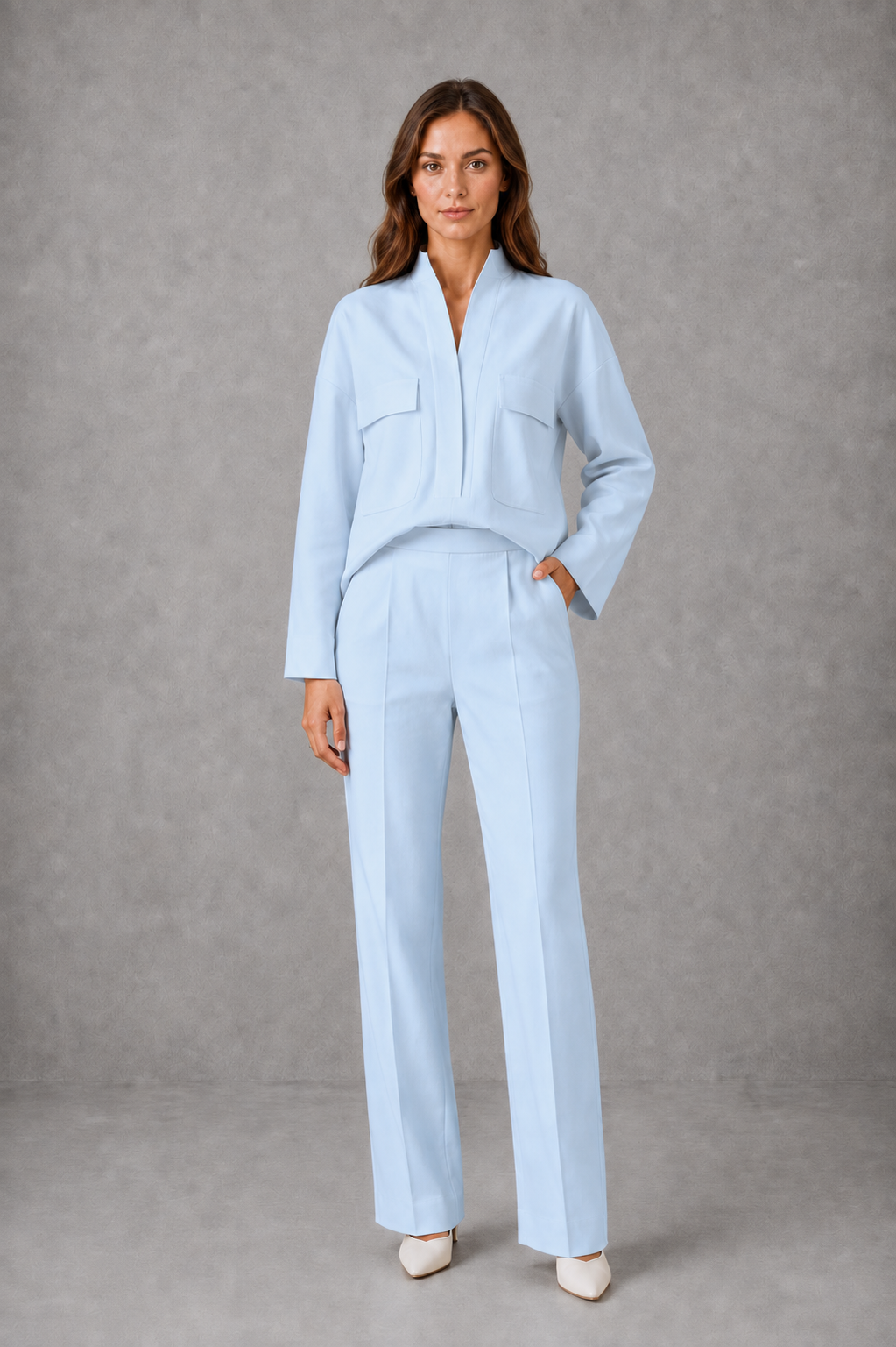 Women’s two-piece set featuring a cropped oversized V-neck jacket with patch pockets and matching high-waisted cigarette pants.