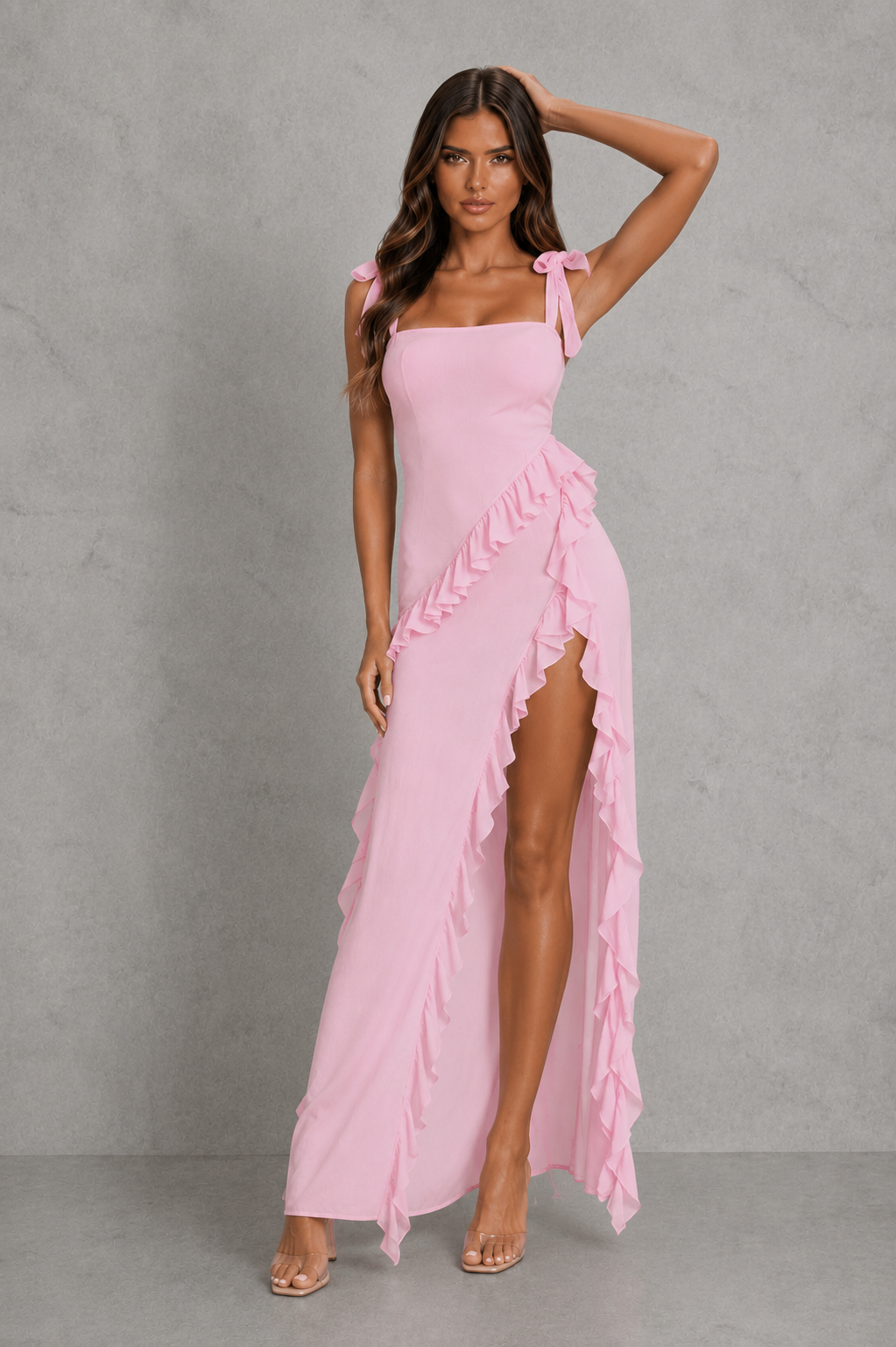 Women’s floral ruched maxi dress with rose appliqué accents, adjustable straps and cascading ruffle detail in soft pink tones for occasion wear.