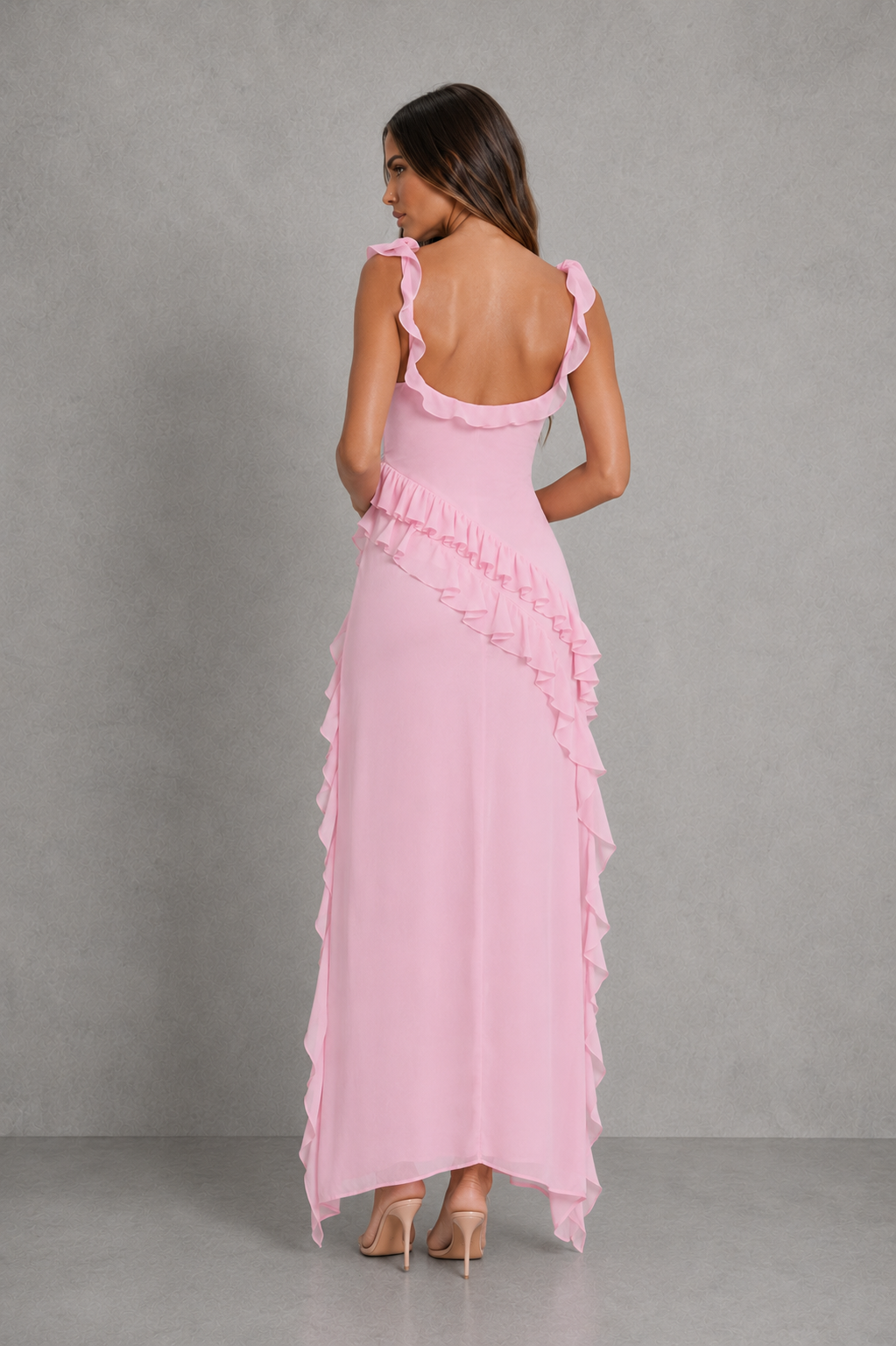 Women’s floral ruched maxi dress with rose appliqué accents, adjustable straps and cascading ruffle detail in soft pink tones for occasion wear.