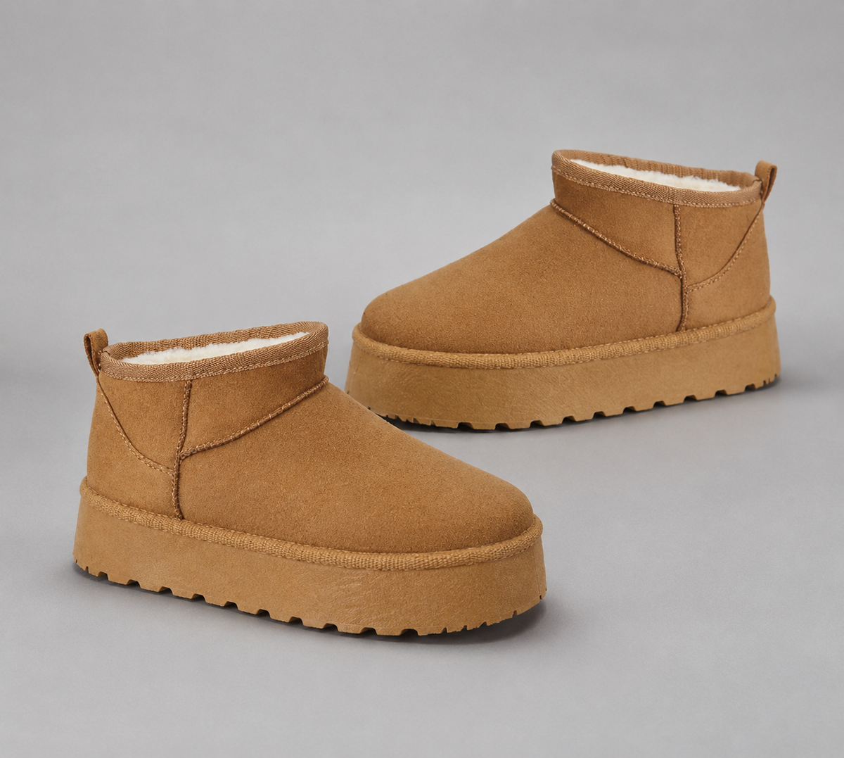 Women’s fur-lined platform snow boots with a soft faux suede upper, plush lining, round toe, back pull tab, and chunky platform sole.