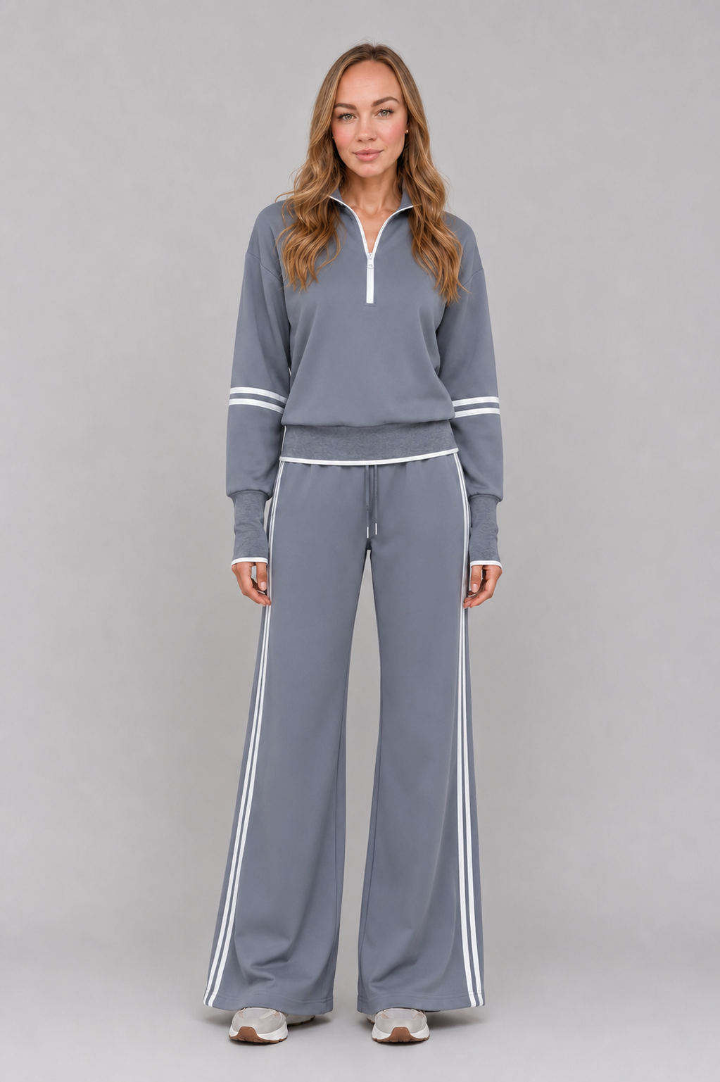 Women’s half-zip lounge set with a relaxed funnel-neck sweatshirt, contrast stripe detailing, and matching wide-leg drawstring pants.