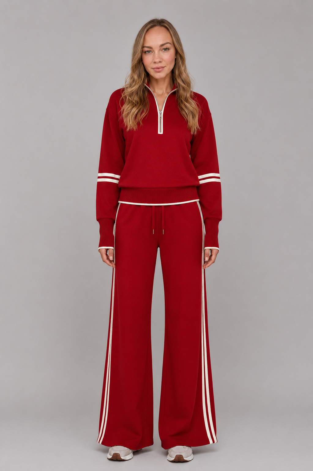 Women’s half-zip lounge set with a relaxed funnel-neck sweatshirt, contrast stripe detailing, and matching wide-leg drawstring pants.
