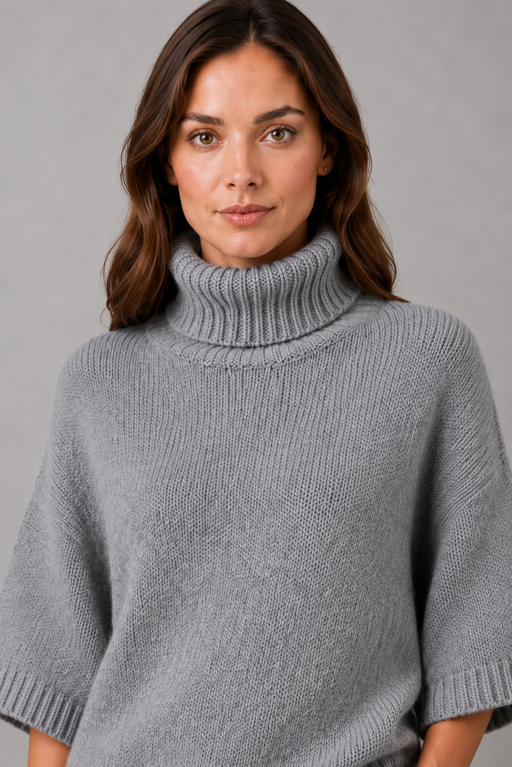 Women’s high neck batwing knit sweater with textured detailing, relaxed poncho-style silhouette, flowing sleeves, and a flattering waist-defining shape.