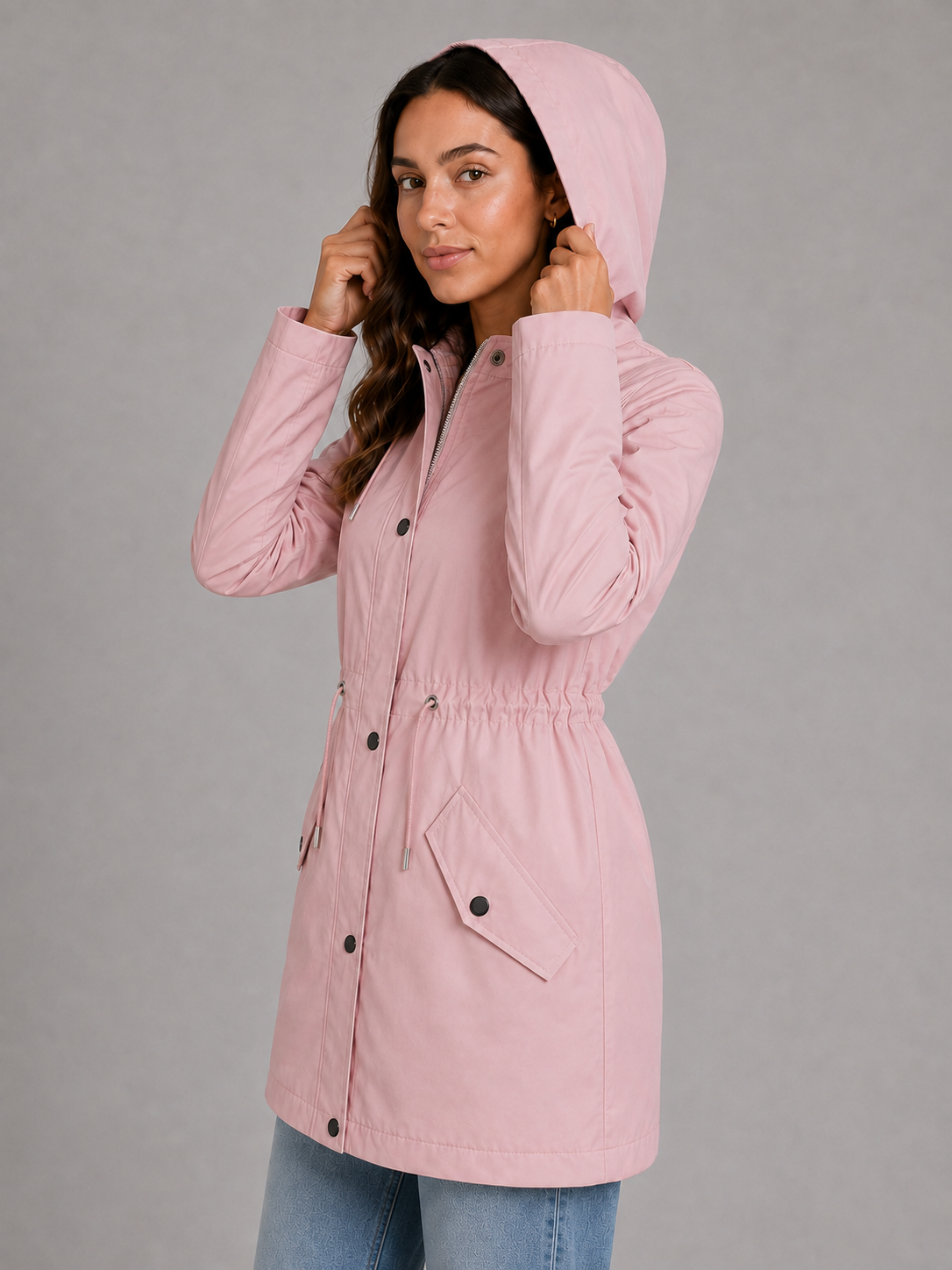 Women’s hooded water-resistant parka with a high collar, adjustable drawstring waist, zip front, snap-button storm flap, and functional flap pockets.