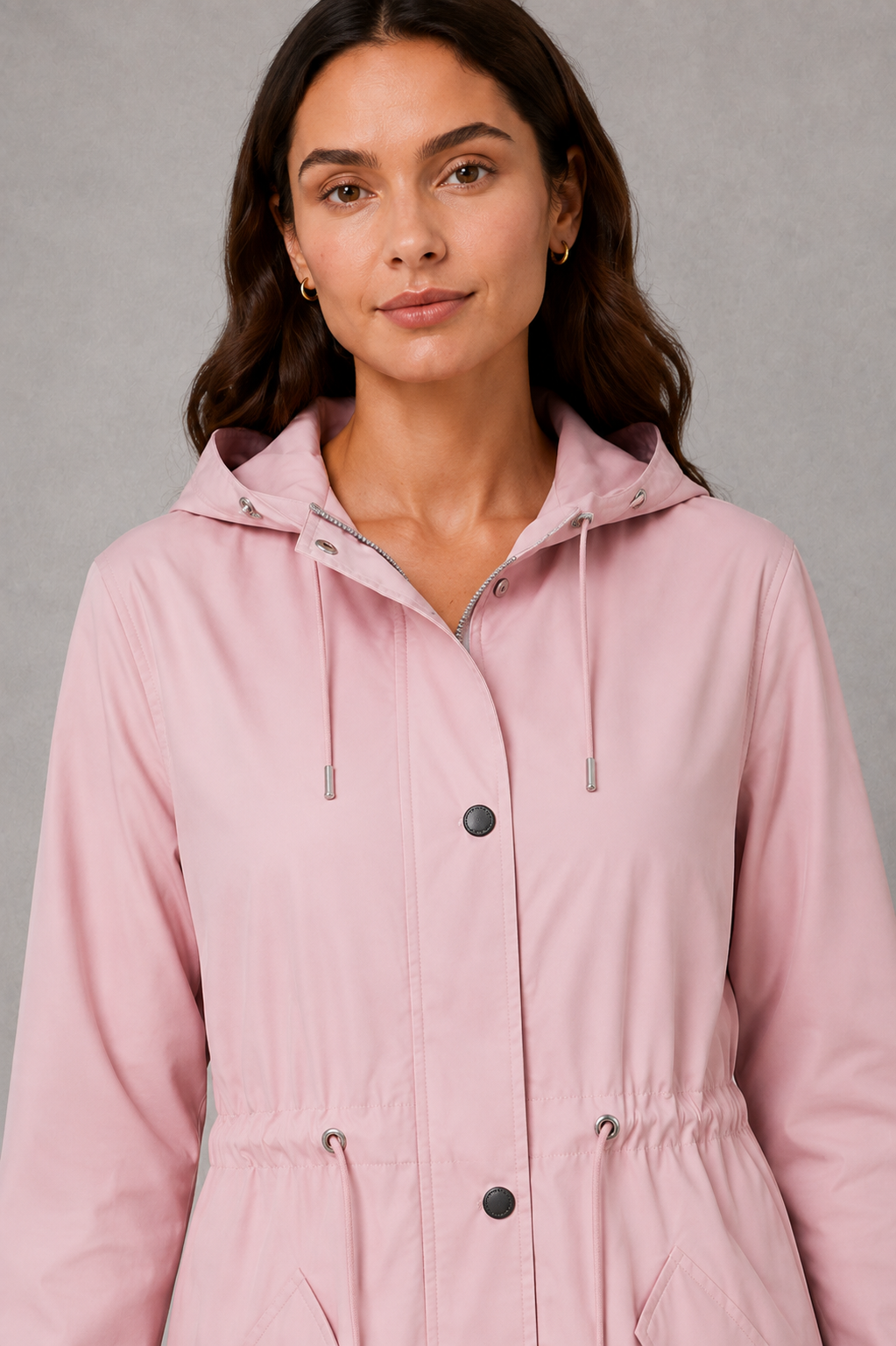 Women’s hooded water-resistant parka with a high collar, adjustable drawstring waist, zip front, snap-button storm flap, and functional flap pockets.