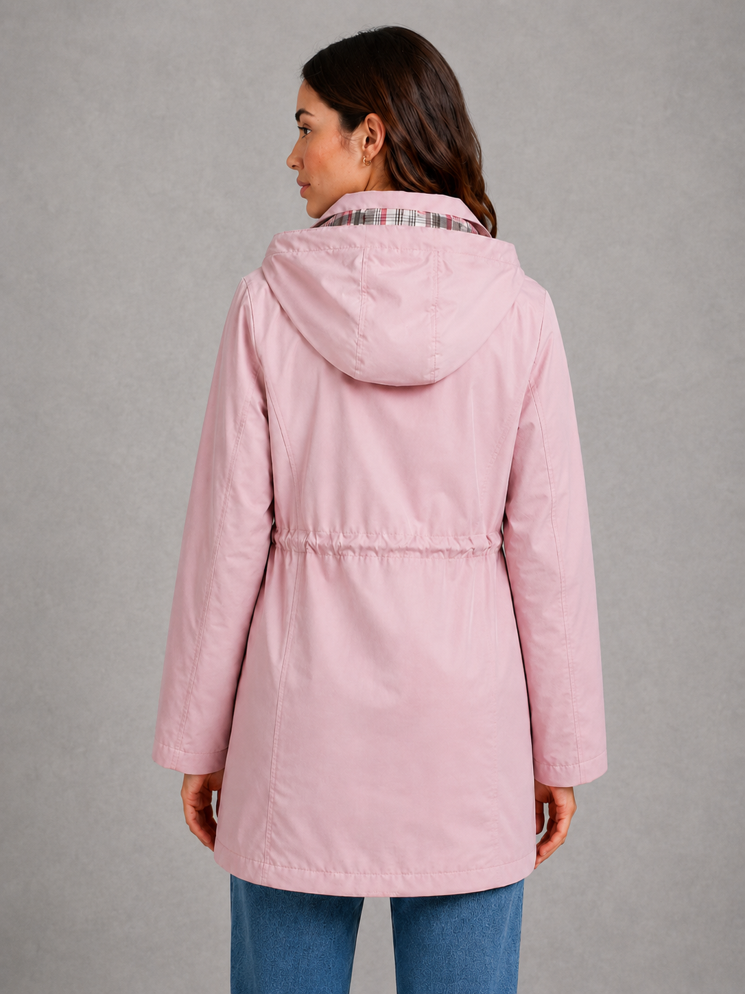 Women’s hooded water-resistant parka with a high collar, adjustable drawstring waist, zip front, snap-button storm flap, and functional flap pockets.