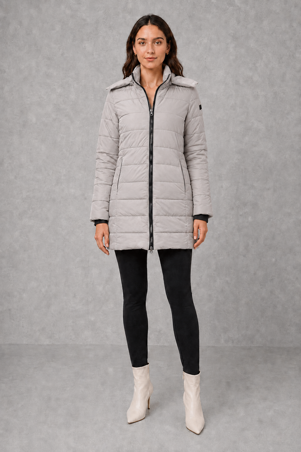 Women’s insulated hooded puffer coat with lightweight padding, protective hood, full-length front zipper, and a streamlined silhouette for cold-weather wear.