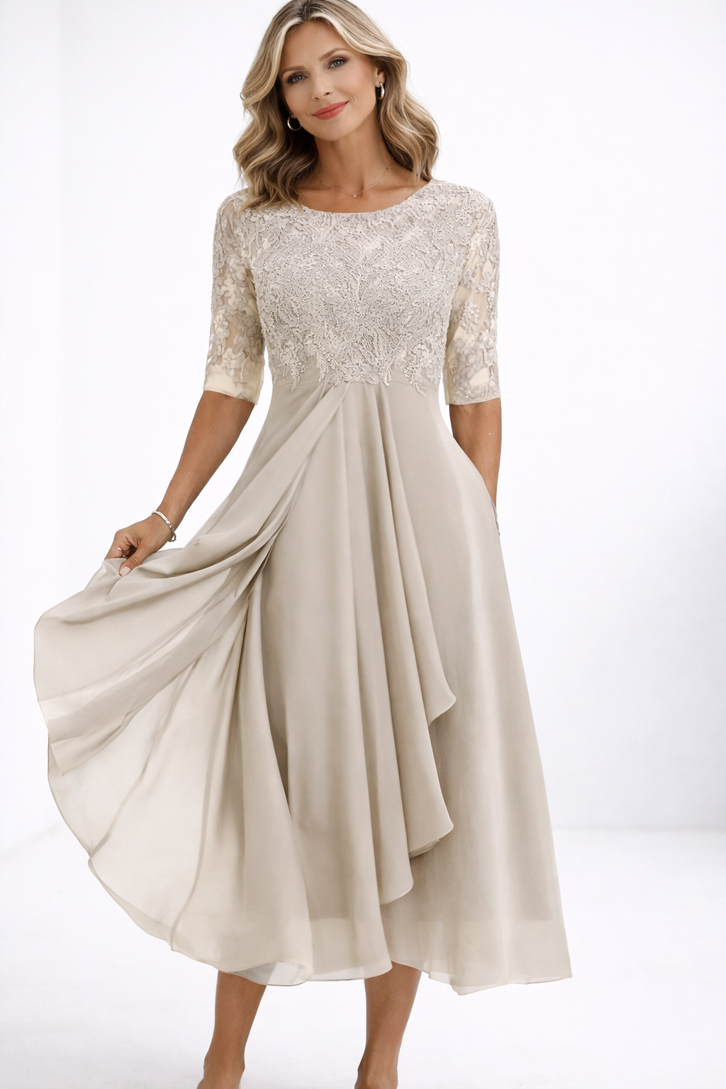 Woman wearing a beige dress with lace top on a white background