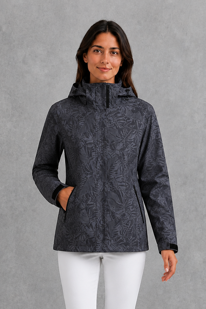 Women’s leaf print hooded rain jacket with a botanical pattern, adjustable drawstring waist and lightweight waterproof, windproof construction.