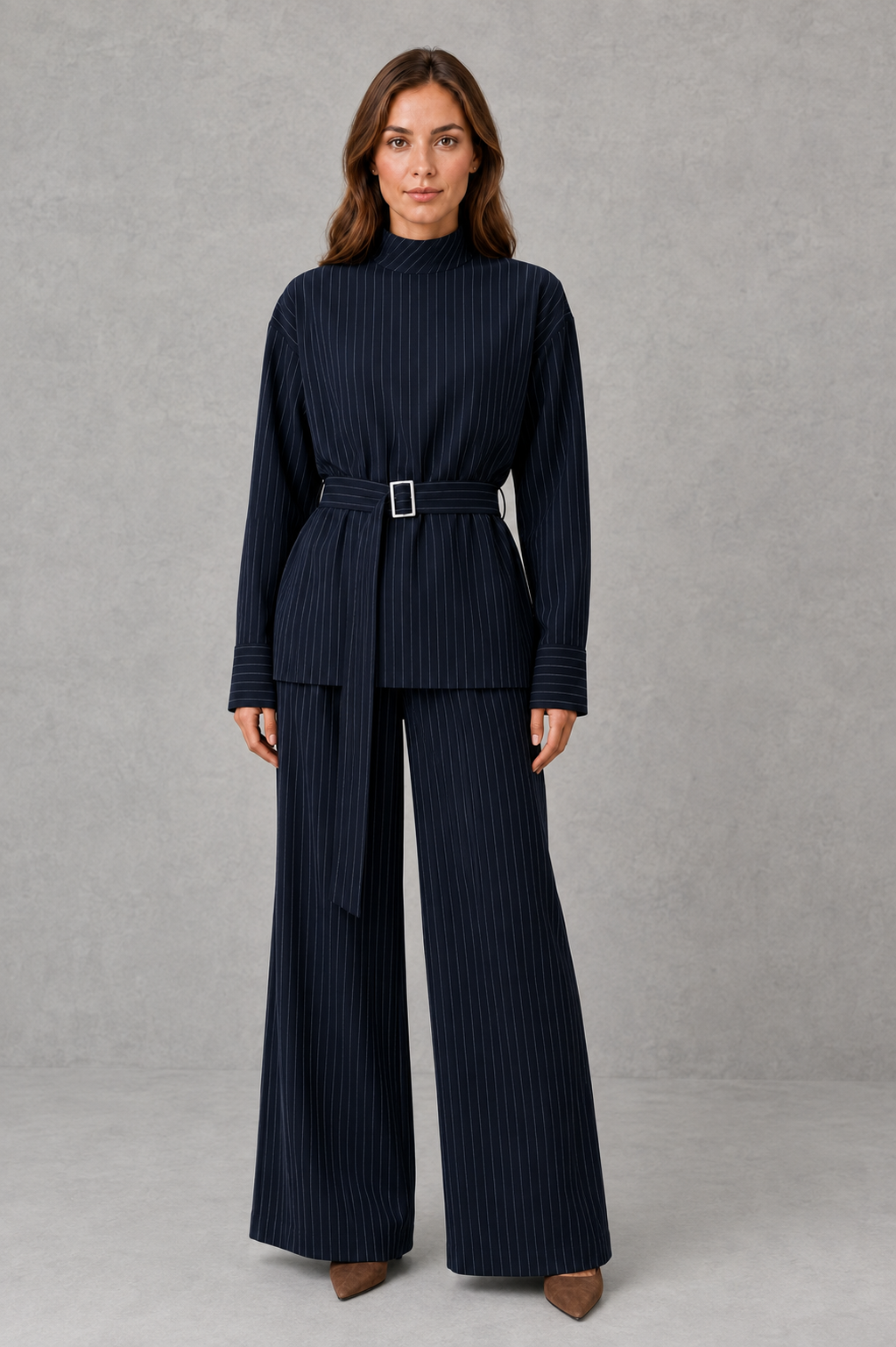 Women’s navy pinstripe two-piece set featuring a long-sleeve high-neck top with a belted waist and matching wide-leg pants.