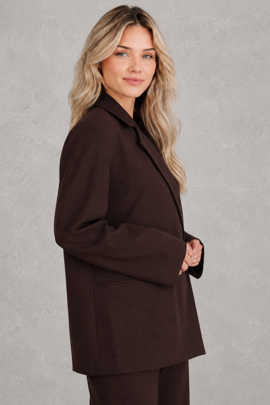 Women’s oversized asymmetrical blazer with a modern button-front closure, structured shoulders, side slits, and a relaxed tailored silhouette.