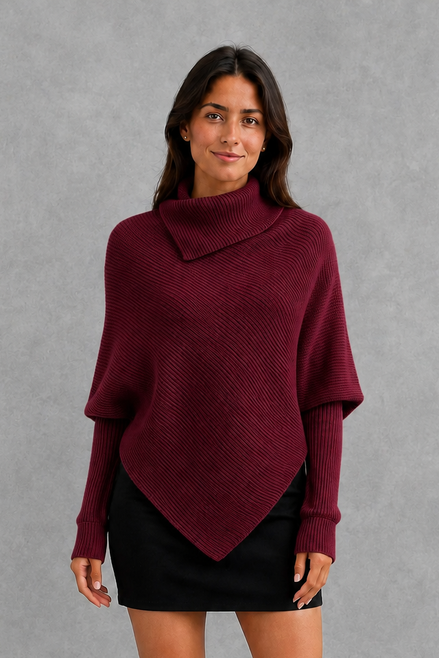 Women’s burgundy oversized batwing sweater with a cozy high neck, long relaxed sleeves, rib-knit texture and modern asymmetrical split hem.