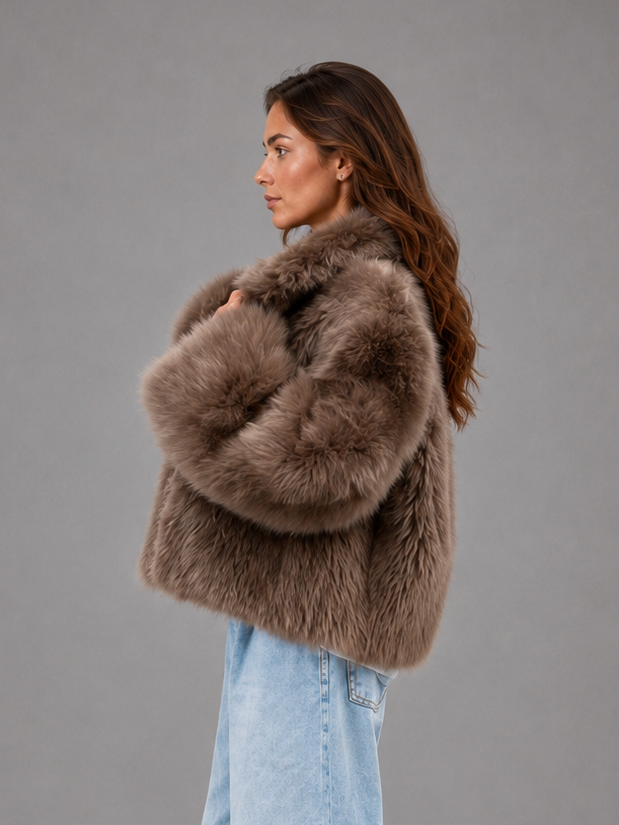 Women’s oversized faux fur coat with a soft plush texture, statement collar and relaxed voluminous silhouette for elegant cold-weather styling.