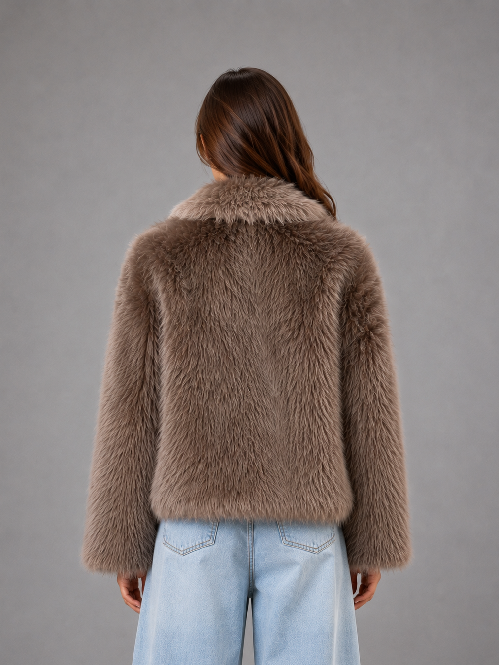 Women’s oversized faux fur coat with a soft plush texture, statement collar and relaxed voluminous silhouette for elegant cold-weather styling.