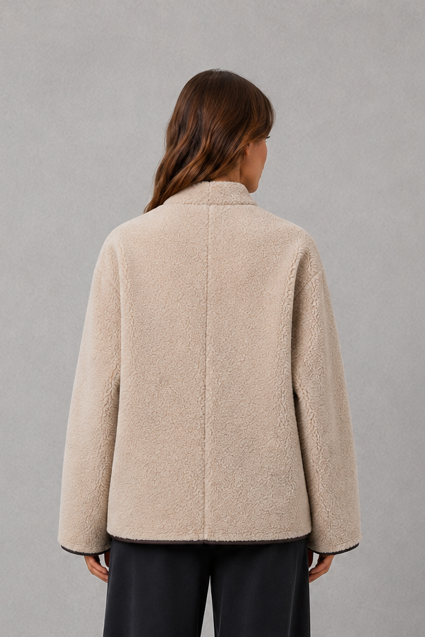 Women’s oversized faux fur toggle jacket with a soft plush texture, contrast trim, classic toggle closures, and two functional front pockets.