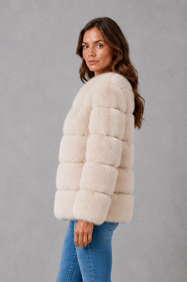 Women’s plush faux fur jacket with a luxuriously soft texture, elegant statement collar and relaxed silhouette for sophisticated cold-weather styling.