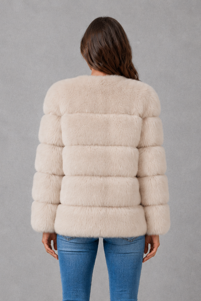 Women’s plush faux fur jacket with a luxuriously soft texture, elegant statement collar and relaxed silhouette for sophisticated cold-weather styling.