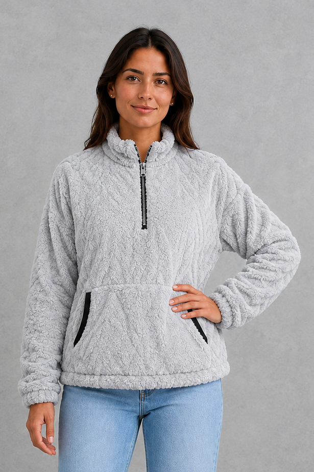 Women’s plush half-zip fleece pullover with a high stand neckline, soft fleece texture, two front pockets, long sleeves, and elasticized cuffs.