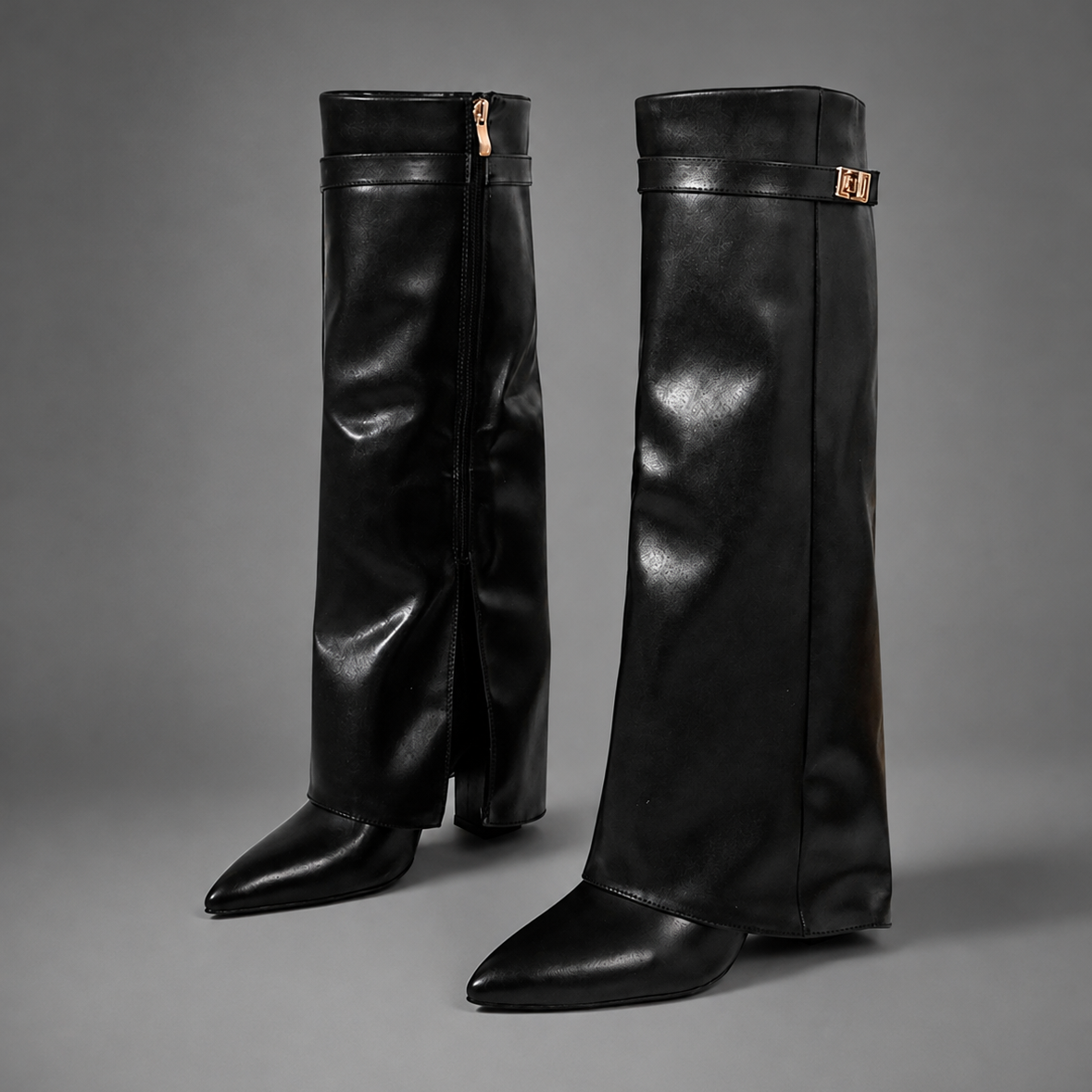 Women’s pointed toe slouch knee-high boots with a relaxed shaft, low block heel, pull-on design, and polished metal cuff detail.