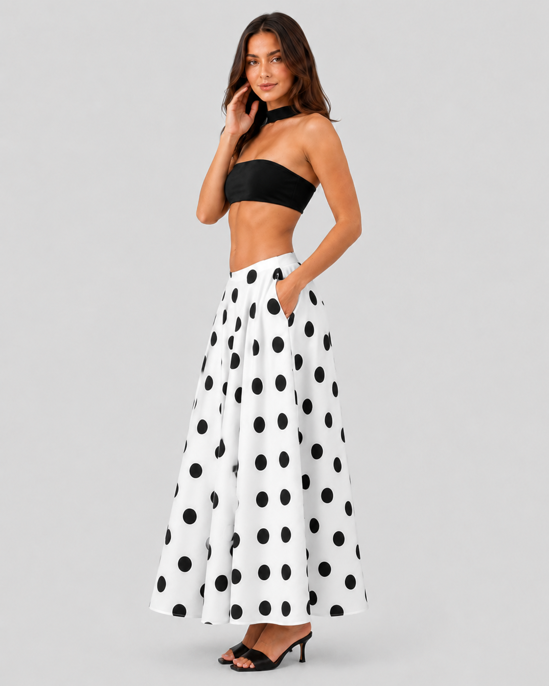 Womenโs flowy maxi skirt featuring a classic black-and-white polka dot pattern, lightweight breathable fabric, and a relaxed silhouette for comfortable everyday wear.