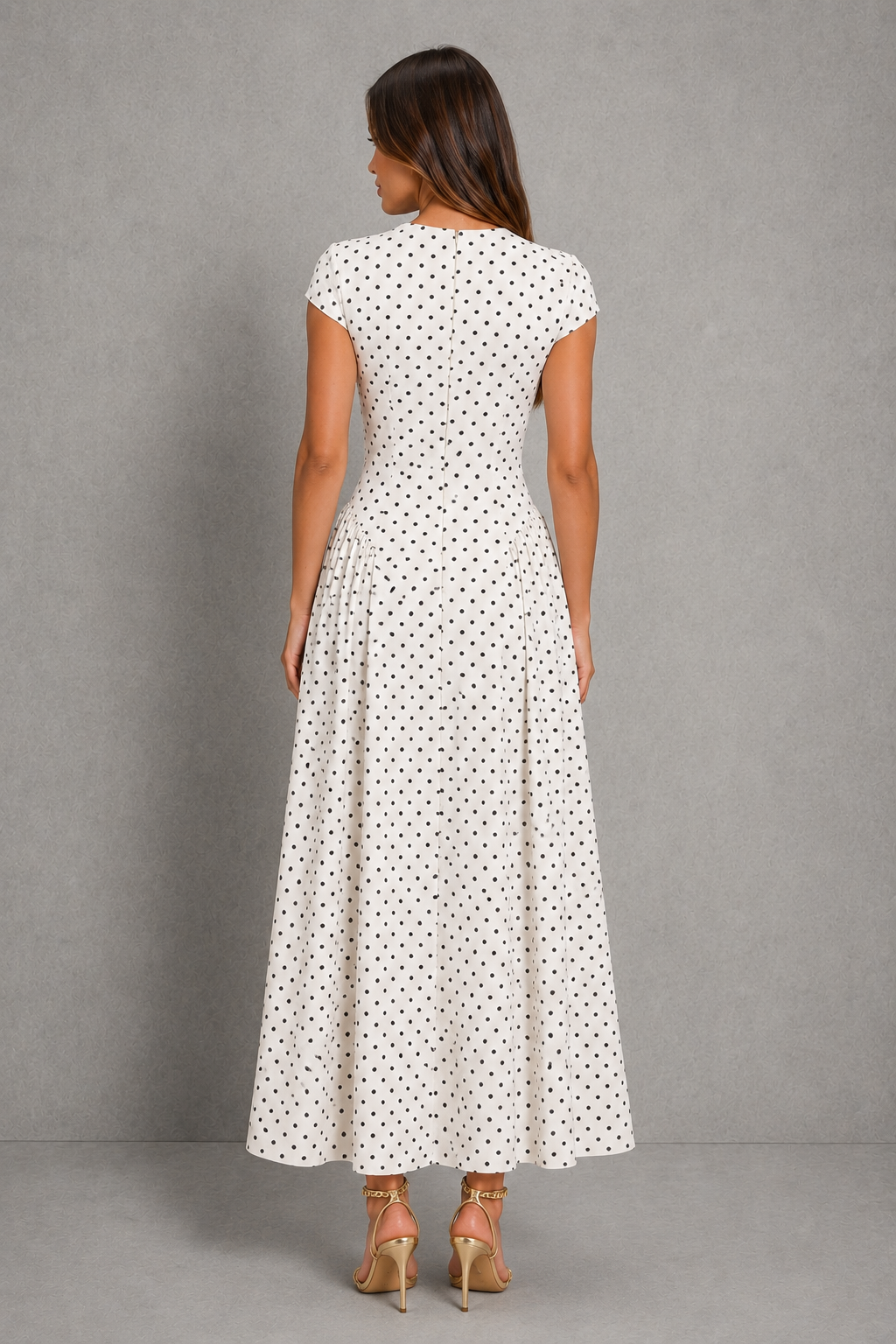 Women's polka dot maxi dress with a high round neckline, cap sleeves, fitted bodice, defined waist, and flowing pleated A-line skirt, ideal for weddings and special occasions.