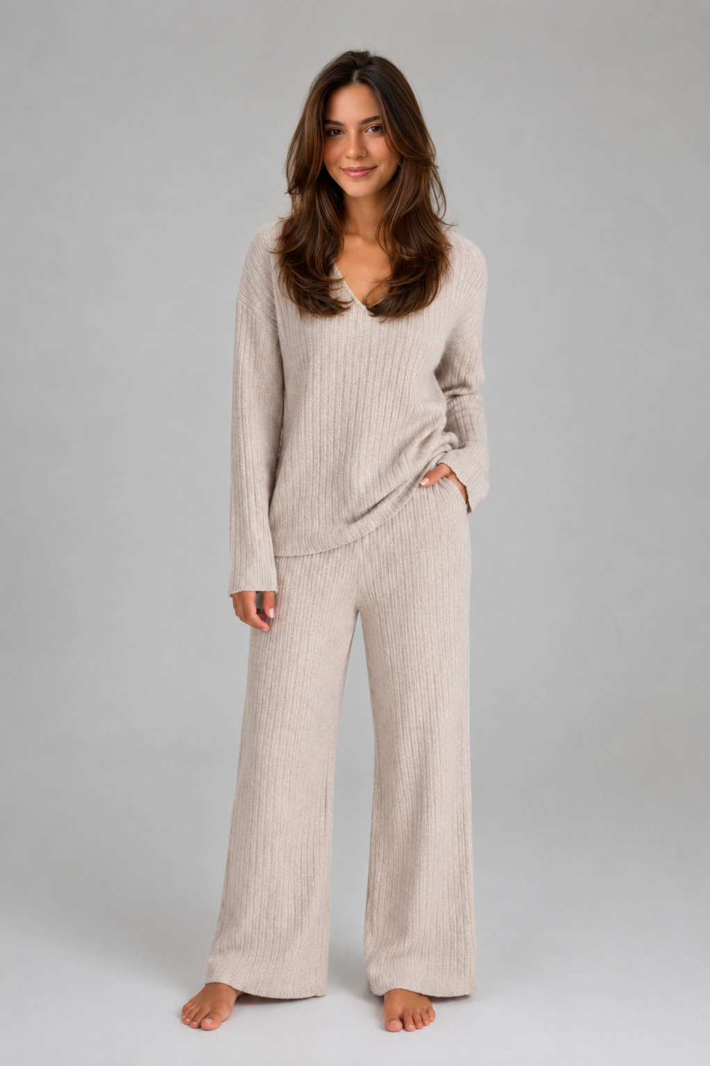 Women’s ribbed knit two-piece lounge set featuring a relaxed V-neck sweater and matching wide-leg pants with a soft, textured finish.