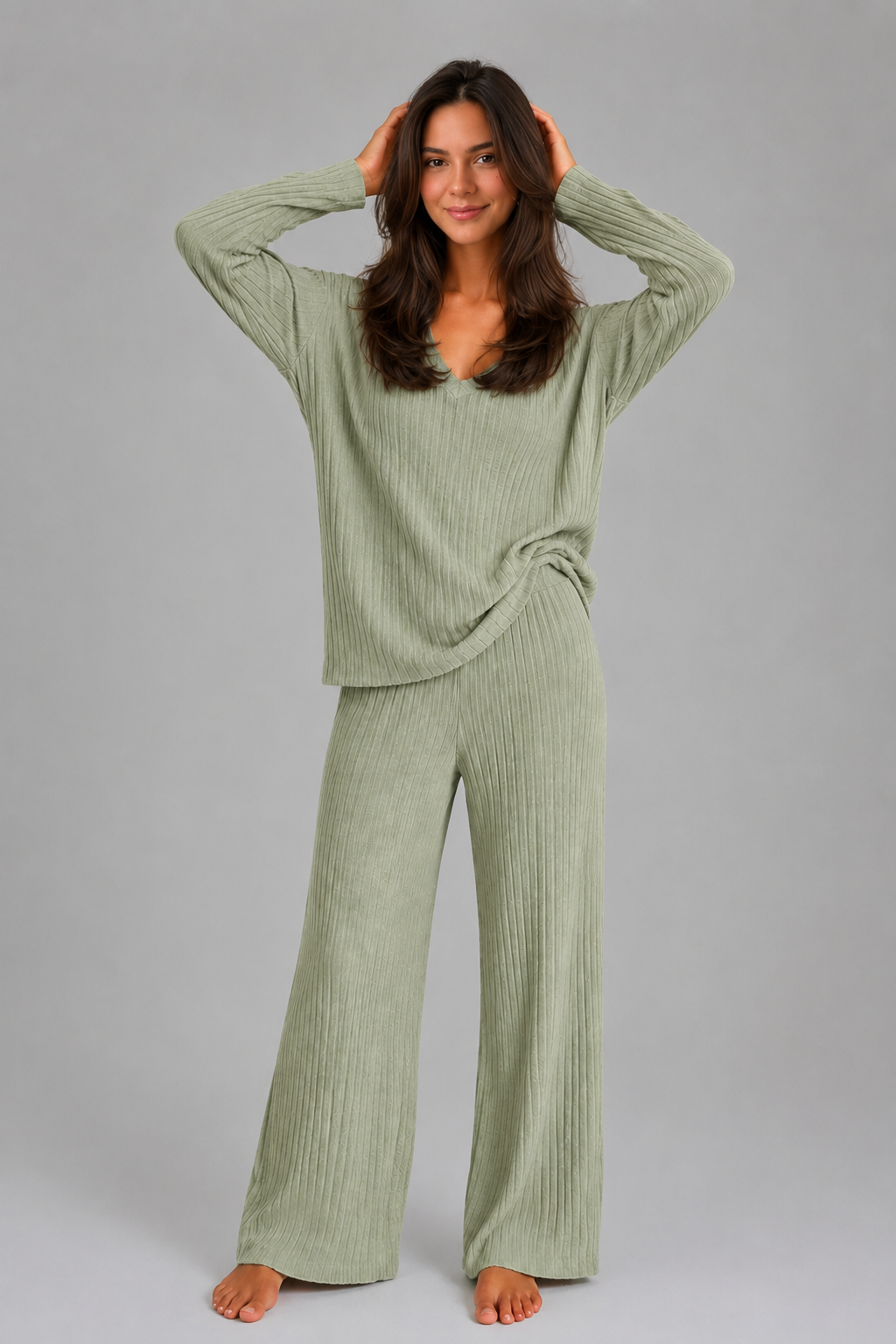 Women’s ribbed knit two-piece lounge set featuring a relaxed V-neck sweater and matching wide-leg pants with a soft, textured finish.