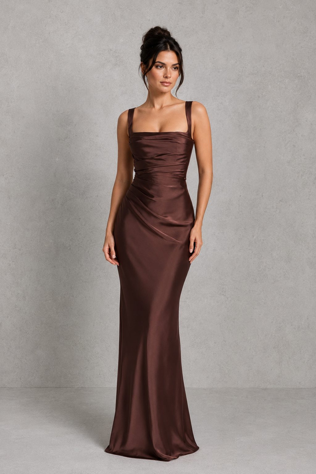 Women's satin maxi dress featuring a structured corset bodice, square neckline, asymmetric pleated detailing, adjustable shoulder straps, and a flowing full-length skirt with a lace-up back, designed for elegant evening events and formal occasions.