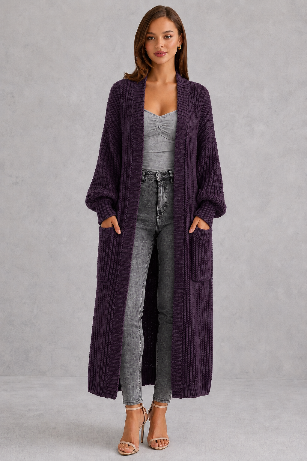 Woman wearing a relaxed-fit V-neck button cardigan sweater with a soft knit texture, styled for elegant autumn and winter layering.