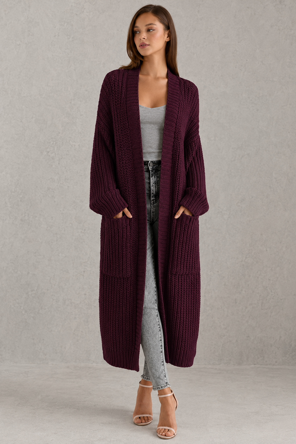 Woman wearing a relaxed-fit V-neck button cardigan sweater with a soft knit texture, styled for elegant autumn and winter layering.