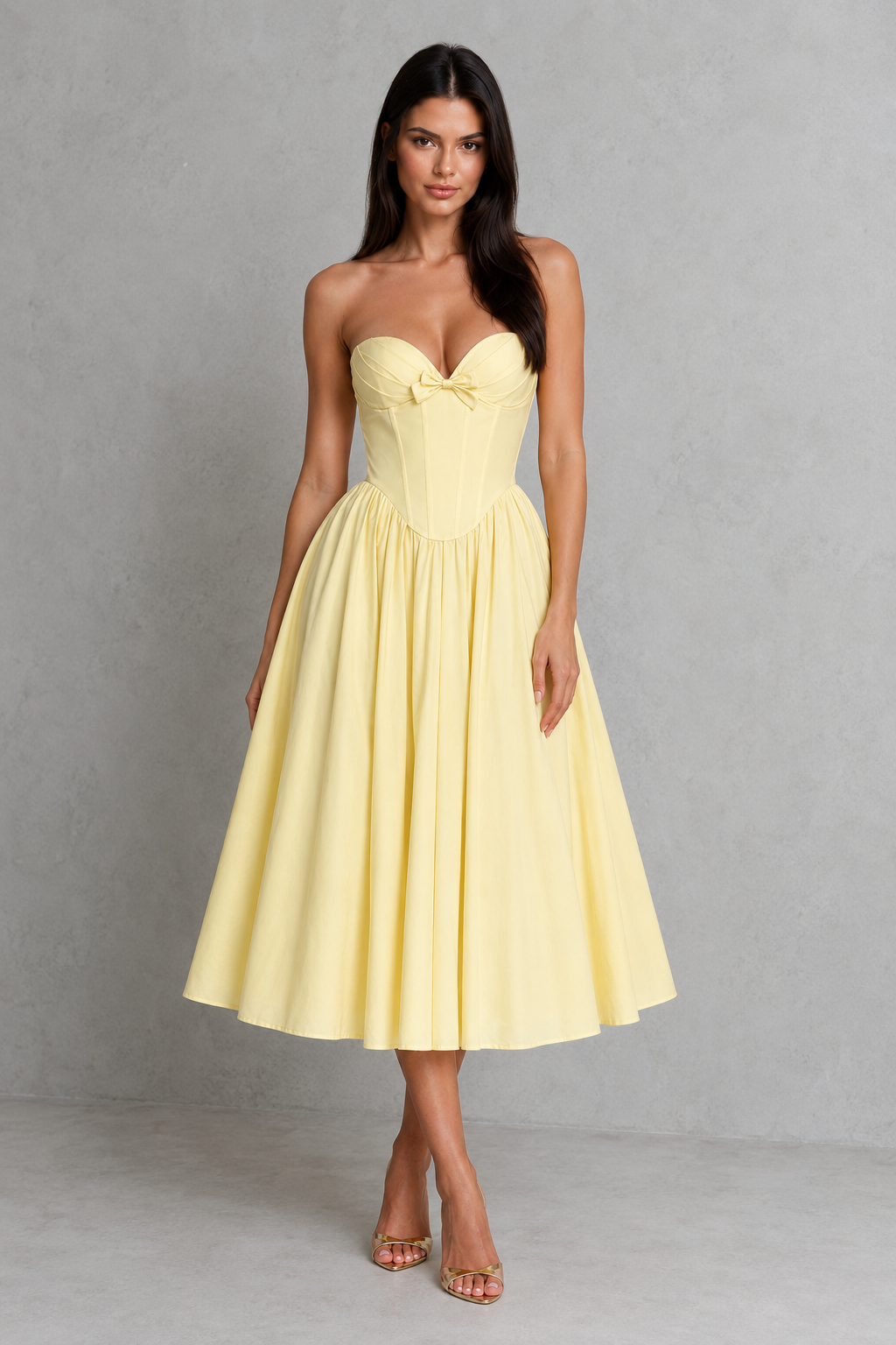 Women's strapless corset midi dress with a sweetheart neckline, pleated cups, bow detail, structured boned bodice, and a full tulle-lined gathered skirt, designed for elegant party and occasion wear.