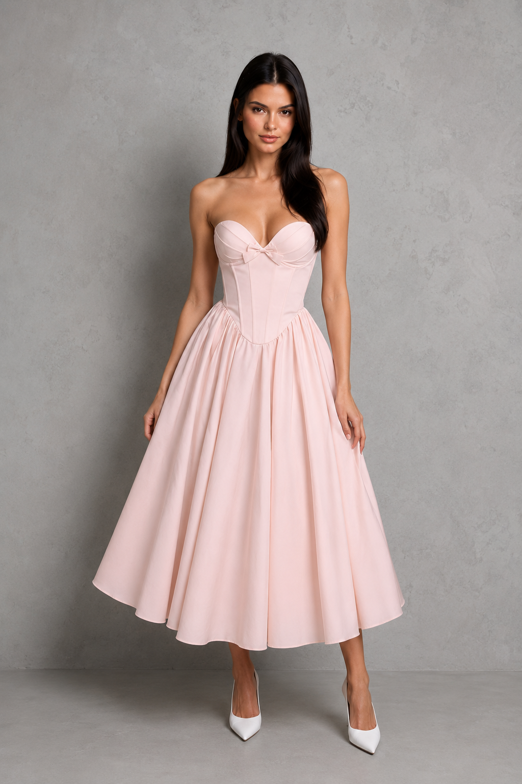Women's strapless corset midi dress with a sweetheart neckline, pleated cups, bow detail, structured boned bodice, and a full tulle-lined gathered skirt, designed for elegant party and occasion wear.