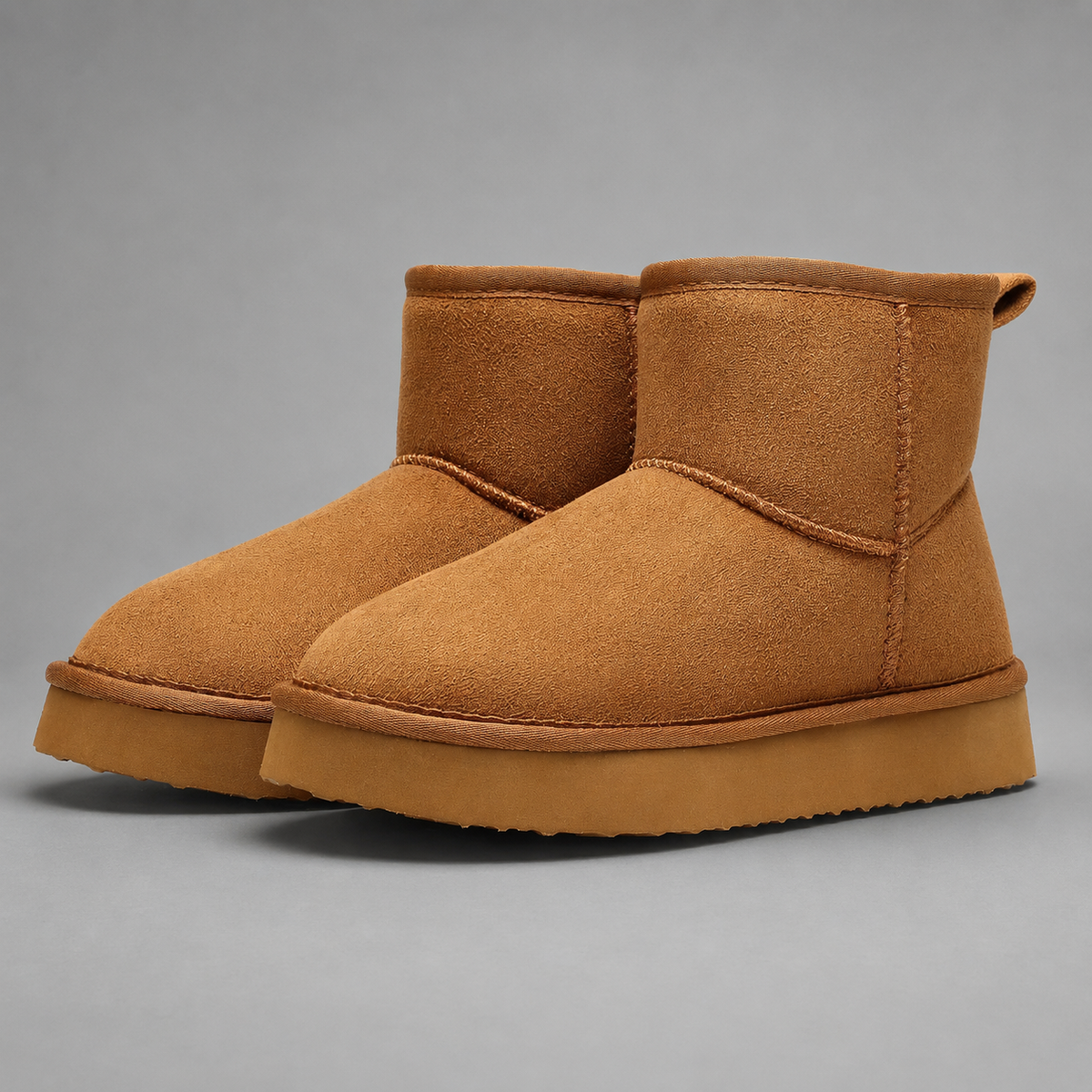 Women’s faux suede platform ankle boots with plush fur lining, chunky 2-inch sole, slip-on design, and rear pull tab.