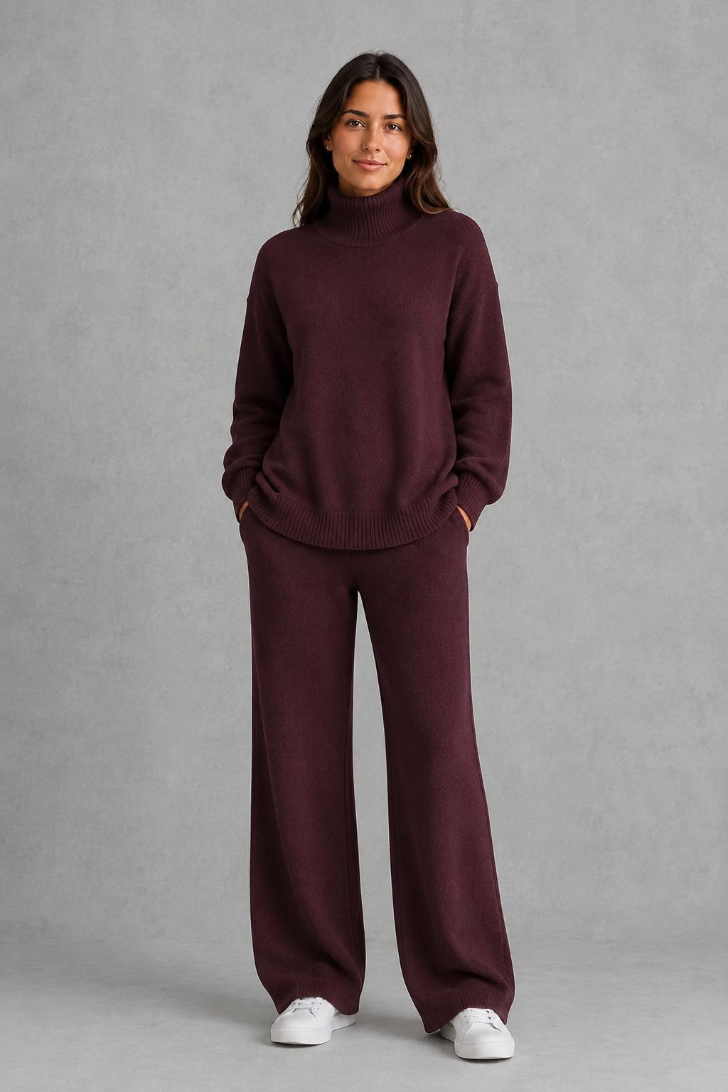 Women’s turtleneck sweater and pants set with an oversized ribbed high-neck sweater, dropped shoulders, long sleeves, and matching wide-leg knit pants.