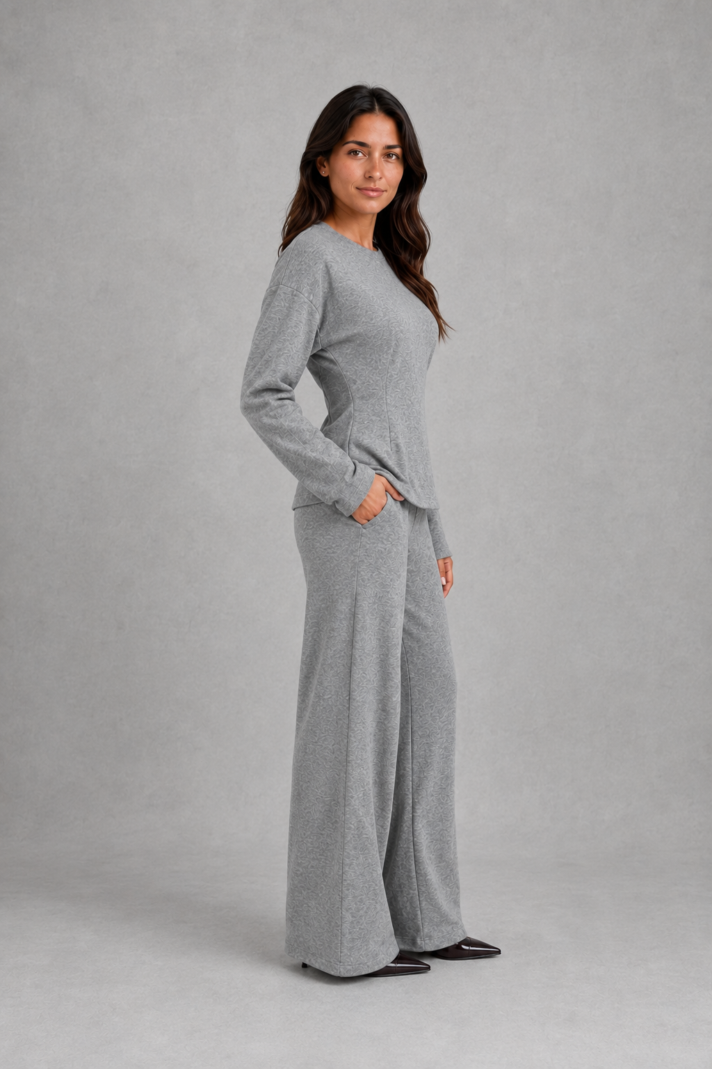 Women’s two-piece lounge set featuring a softly fitted long-sleeve crew neck top with a shaped waist and matching wide-leg pants with side pockets.