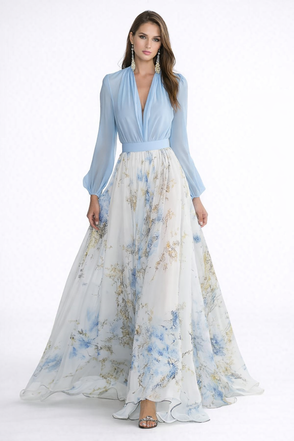Woman wearing a light blue top and floral dress on a white background