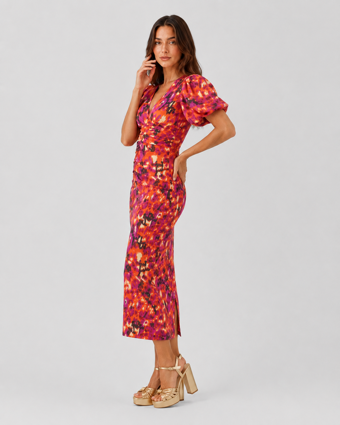 Womenโs Klyne Studios printed midi dress with a V-neckline, structured puff sleeves, relaxed fit, and soft waist shaping for a modern, versatile look.