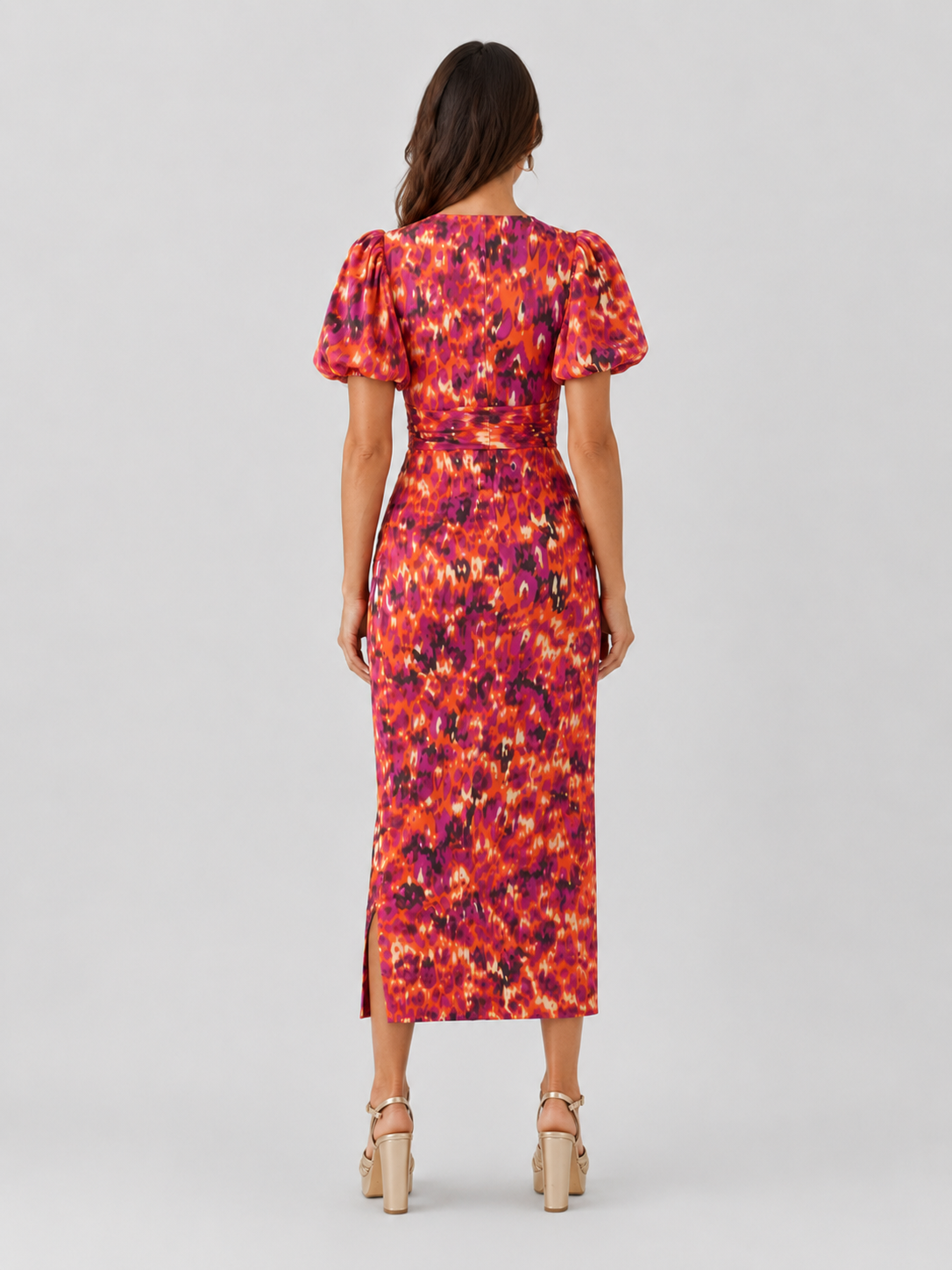 Womenโs Klyne Studios printed midi dress with a V-neckline, structured puff sleeves, relaxed fit, and soft waist shaping for a modern, versatile look.