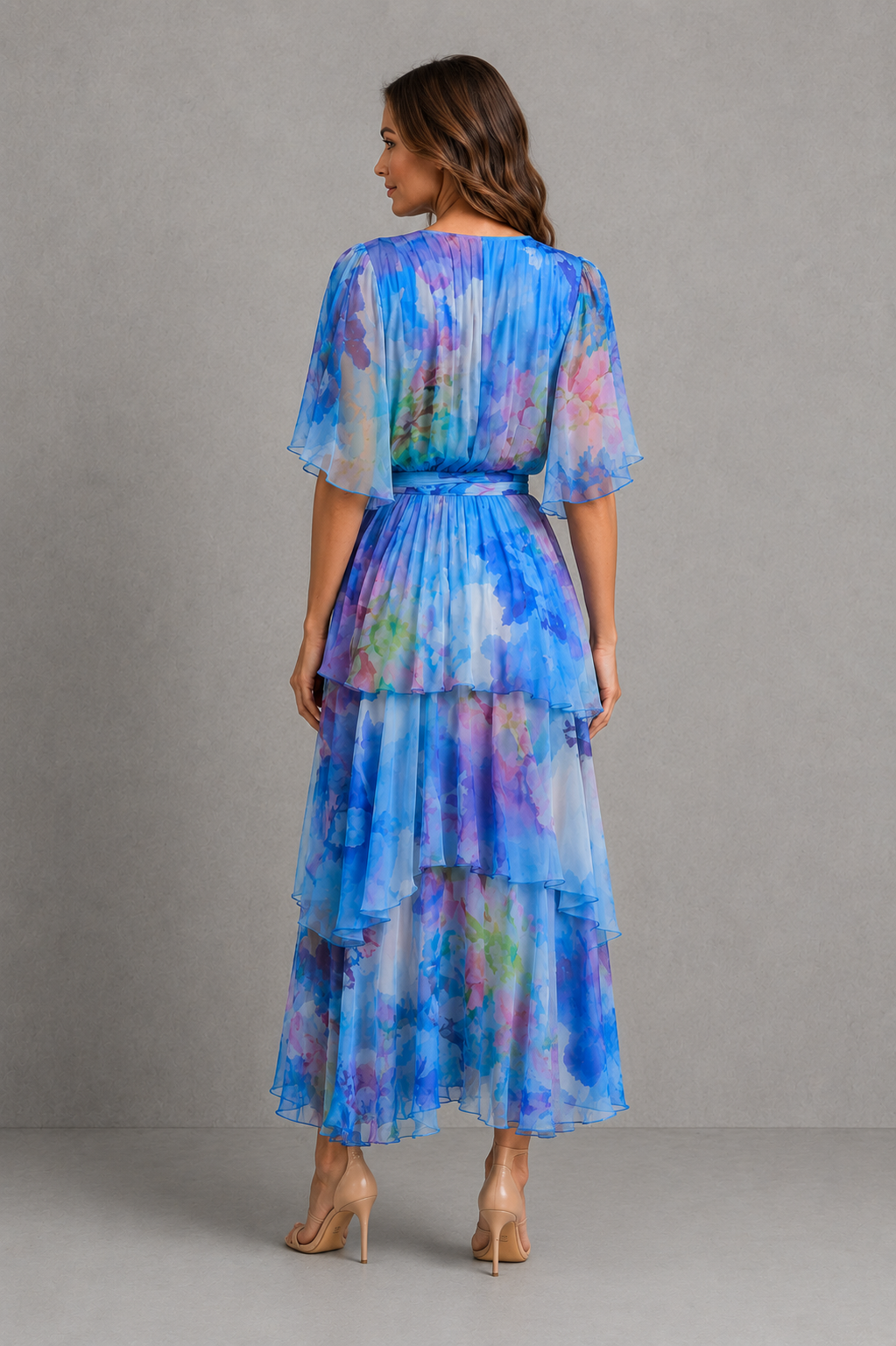 Womenโs watercolour chiffon maxi dress with wrap V-neckline, flutter sleeves, tie waist and tiered skirt in soft pastel floral tones.