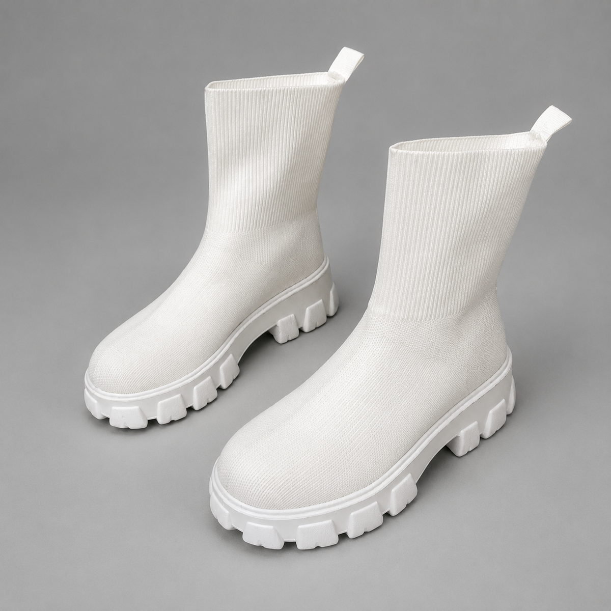 Women’s waterproof ankle boots with a flexible stretch upper, warm faux fur lining, slip-on design, lace-up accents, and non-slip rubber outsole.
