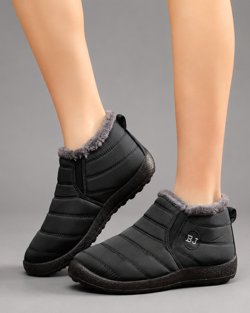 Women’s waterproof snow boots with a quilted upper, warm faux fur lining, round toe, slip-on design, and durable non-slip outsole.