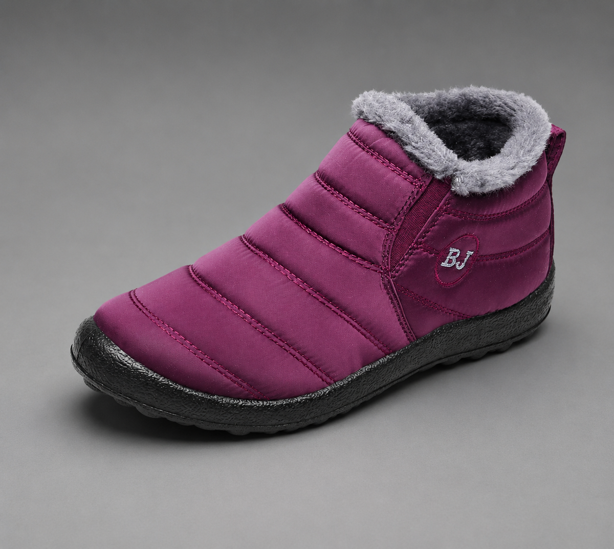Women’s waterproof snow boots with a quilted upper, warm faux fur lining, round toe, slip-on design, and durable non-slip outsole.
