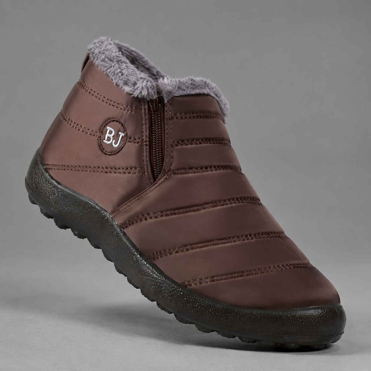 Women’s waterproof snow boots with a quilted upper, warm faux fur lining, round toe, slip-on design, and durable non-slip outsole.