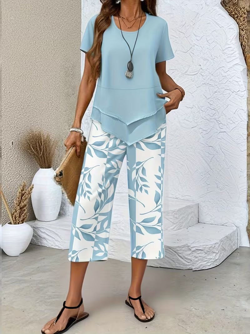 Women’s two-piece outfit featuring a relaxed top and leaf print trousers designed for lightweight and comfortable everyday wear.